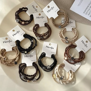 Elastic hair ties set with heart and flower alloy pendants in neutral earthy colors