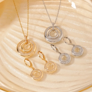 Macro shot of concentric circle jewelry set featuring gold and silver micro-inlaid zircon