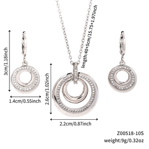 Detailed view of silver double circle necklace and earrings set with micro pave zircons