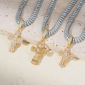 Three gold cross and ankh pendants with micro-pave cubic zirconia on tennis chains