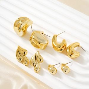 Polished gold geometric earrings with minimalist organic shapes and liquid metal finish
