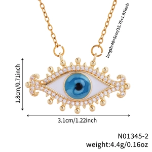 Detail showing gold evil eye pendant with blue eye, white enamel and micro zircons