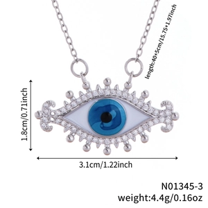 Detailed view of silver evil eye pendant necklace with blue eye and crystal accents