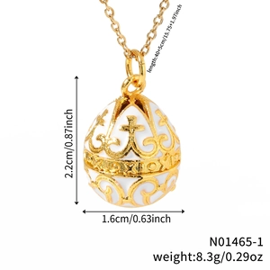 Vintage gold-toned egg pendant necklace with white enamel and ornate floral cross pattern