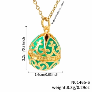 Vintage green enamel egg necklace with gold cross pattern and dimensions display