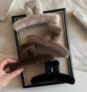Macro view of plush faux fur large shark hair claws in four autumn colors display