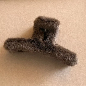 Detailed close-up of dark brown faux fur hair claw clip with plush texture and sturdy design