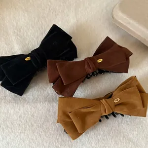 Set of large velvet bow hair clips in black, brown and yellow with gold metal accents