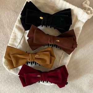 Set of four vintage velvet bow hair clips with gold metal charms in assorted colors