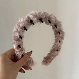 Détail du serre-tête en fausse fourrure rose poudré avec dents de peigne antidérapantes