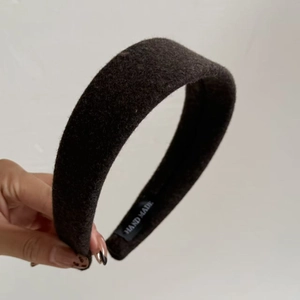 Detail of handmade wool felt headband featuring thick design and interior hand-made label