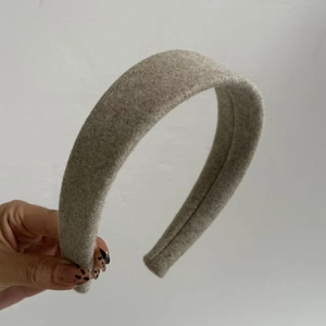 Detail view of the gray woolen fabric texture on a wide-brimmed padded headband