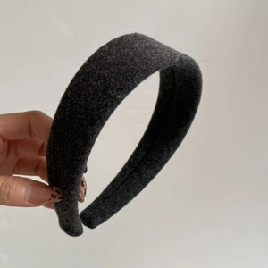Close-up of thick dark grey wool headband with soft padded fabric and neat stitching