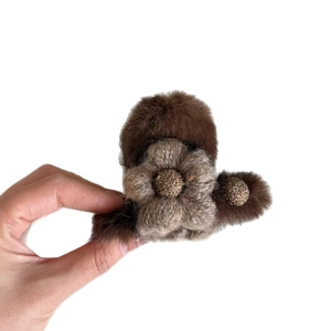 Brown plush flower hair claw clip with a soft fuzzy texture for elegant hairstyles