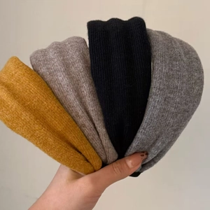 Set of four wide knitted wool headbands in yellow, coffee, black, and grey for women