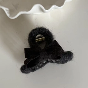 Elegant black plush bow hair claw clip with soft faux fur and minimalist shark clip design