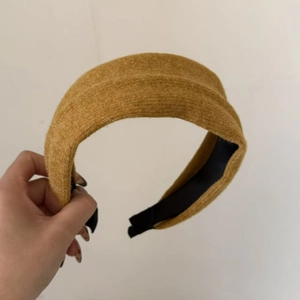 Close-up of ginger yellow wool headband with soft knit texture and thick padded design