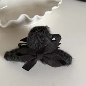 Elegant plush faux fur hair claw with double black bowknot design for winter styling