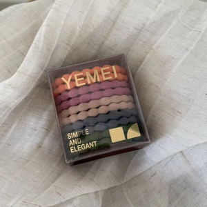 Close-up of colorful high-elasticity hair ties set in an elegant transparent gift box