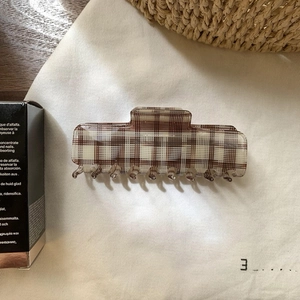 Elegant brown checkered geometric square hair claw clip for women on soft fabric