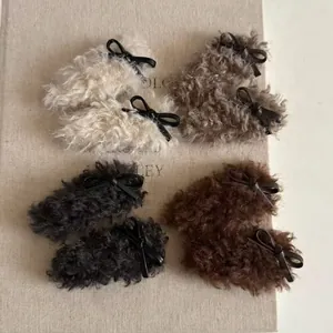 Set of 8 plush faux shearling hair clips in four colors with black bow accents