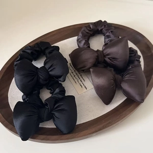 Elegant satin bow scrunchie set in black and dark coffee colors for hair styling