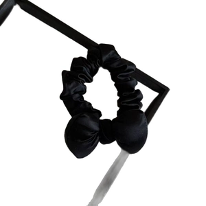 Elegant black satin bow scrunchie for women with high-gloss finish for sleek ponytails