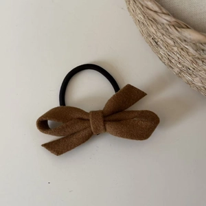 Elegant brown wool bow hair scrunchie with high elasticity rubber band on neutral background