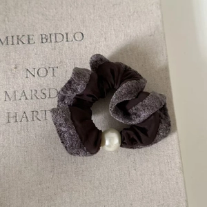 Elegant velvet and plush scrunchie with a large pearl detail for autumn hair styling