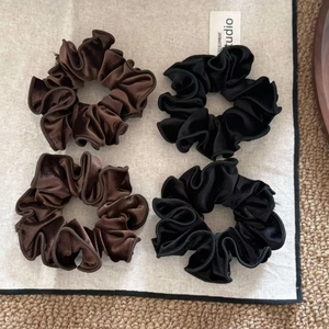 Set of four minimalist velvet scrunchies in dark brown and black colors for women