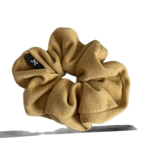 Knitted oversized scrunchie in mustard yellow with bow label for messy buns