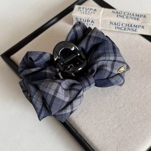 Navy blue plaid bow hair claw clip with golden metal tag in a stylish academy retro design