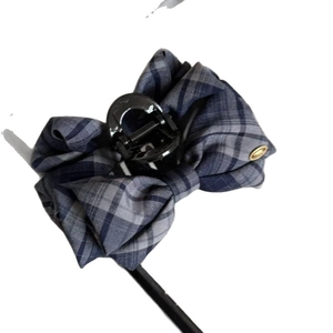 Retro navy blue plaid bow hair claw clip with a gold decorative accent for women