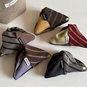 Detail of triangular striped knit fabric hair claw clips with handmade fabric labels