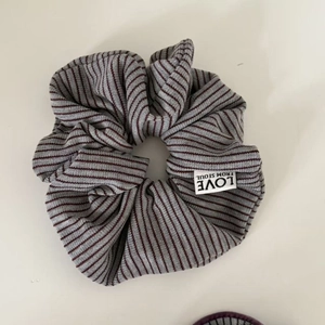 Gray and purple striped scrunchie with Love From Seoul label and knitted texture