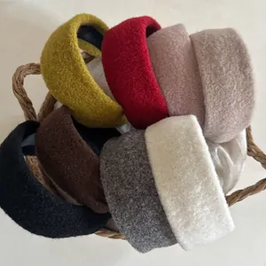 Macro shot of plush velvet headbands in assorted colors inside a woven storage basket