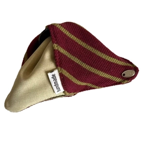 Red and gold striped fabric hair claw clip with handmade label on white background