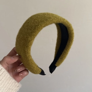 Detailed view of olive green plush knit headband with soft texture and non-slip lining