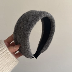 Detail showing grey bouclé padded headband texture with thick warm knit fabric