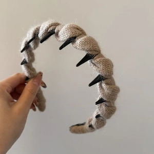 Detail view of the knit wool texture and black inner teeth for non-slip hair styling