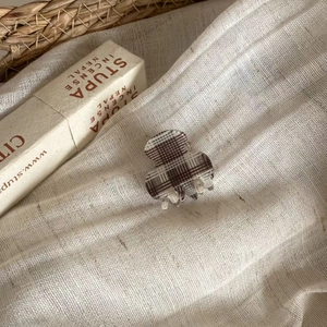 British style plaid hair claw clip in coffee and cream brown resin on linen background