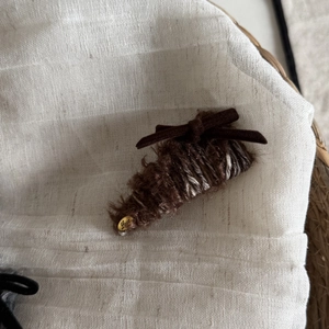 Plush brown velvet bow hair clip with a gold Love pendant for an autumn winter style