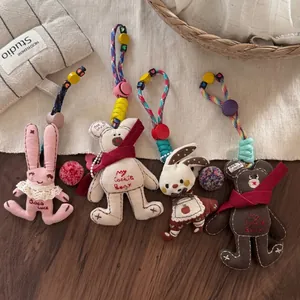 Set of four cute fabric animal keychains with lace details and colorful beaded lanyards