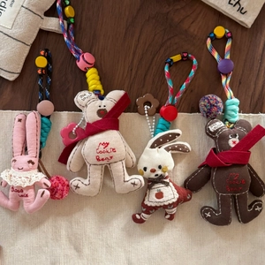 Cute pink lace rabbit and teddy bear plush keychains with colorful woven lanyards