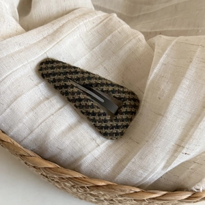 Close-up of Fair Isle pattern tweed BB hair clip with dark brown and black woven texture