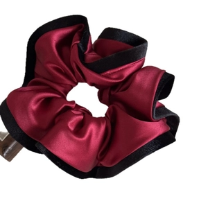 Elegant deep red satin scrunchie with black velvet trim edge on white background
