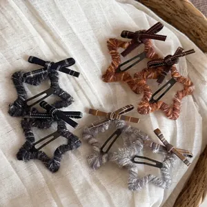 Star-shaped plush hair clips with plaid bows for women in neutral cozy colors