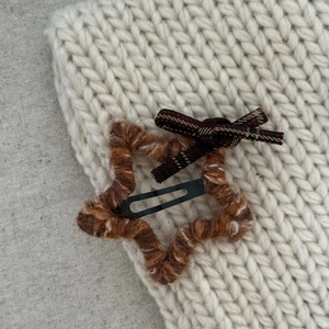 Star-shaped plaid bow hair clip with brown checkered pattern and wool knit texture