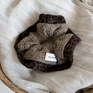 Detail of leopard print and brown waffle knit scrunchie with handmade woven label