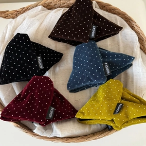 Detailed view of assorted velvet polka dot hair clips in brown, navy and burgundy colors